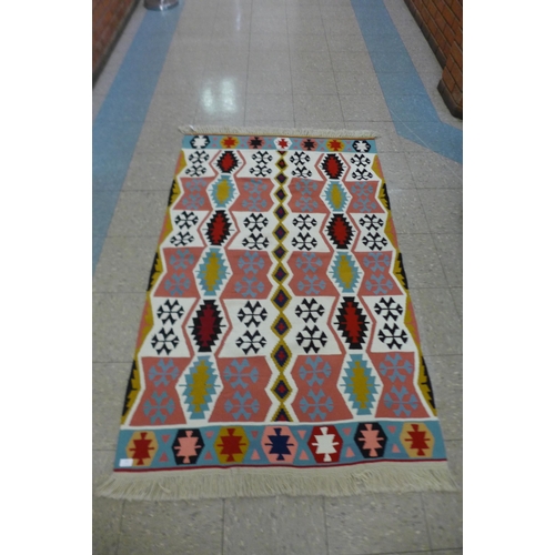 122 - A Turkish Kilim wool and nylon handmade rug, 184 x 110cms