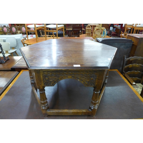 129 - A carved Ipswich oak octagonal coffee table