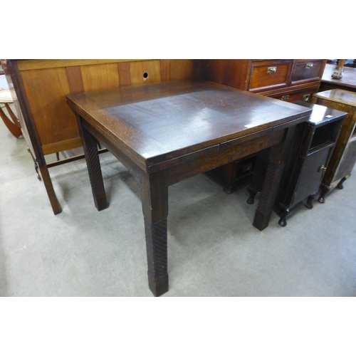 137 - An oak draw-leaf dining table