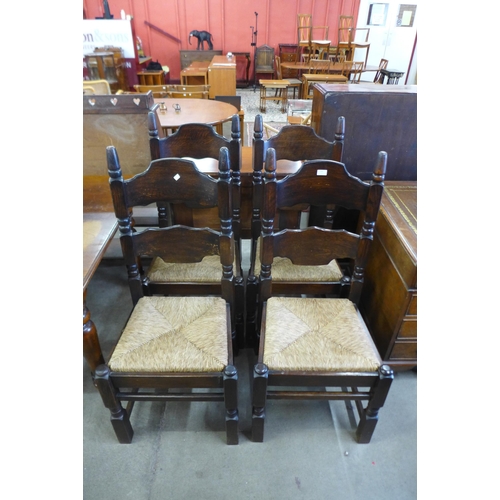 143 - A set of four Dutch oak rush seated chairs