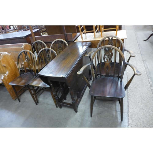 175 - An oak gateleg table and six chairs