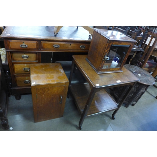 181 - An oak smokers cabinet, oak occasional table and a bedside cupboard