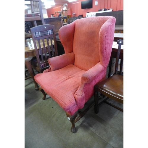 185 - An early 20th Century Queen Anne style walnut and fabric upholstered wingback armchair