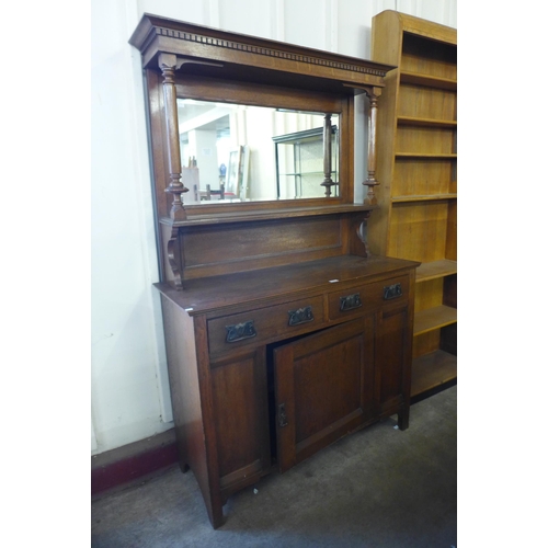 191 - An Arts and Crafts oak mirrorback sideboard