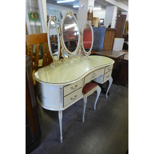 195 - A cream and parcel gilt kidney shaped dressing table and stool