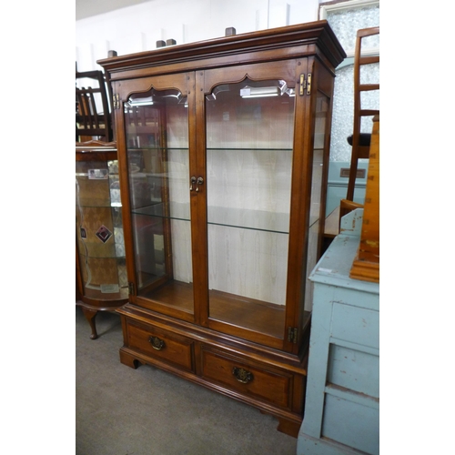 205 - A walnut two door display cabinet, manufactured by Simpsons of Norfolk