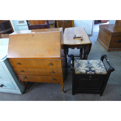 208 - A mahogany piano stool and a walnut bureau