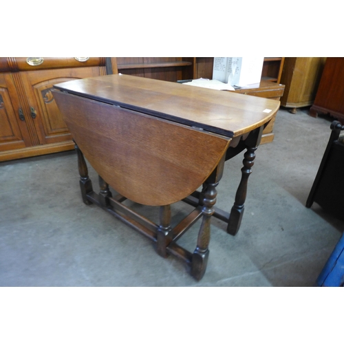 211 - An oak and beech gateleg dining table