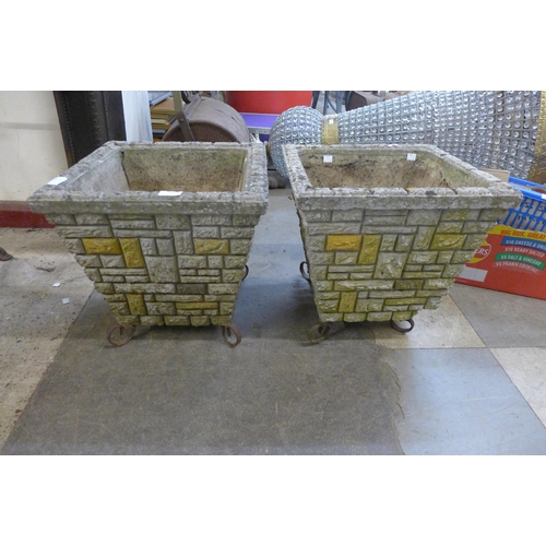 255 - A pair of concrete garden planters on wrought iron legs