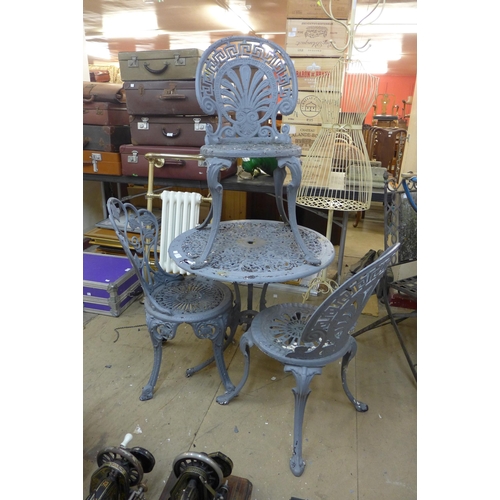 270 - A wrought alloy garden table and three chairs