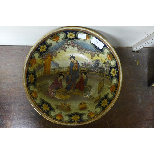 312 - An oriental painted porcelain bowl on ebonised stand