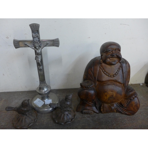 317 - A carved wooden seated Buddha, crucifix and two small cast iron robins