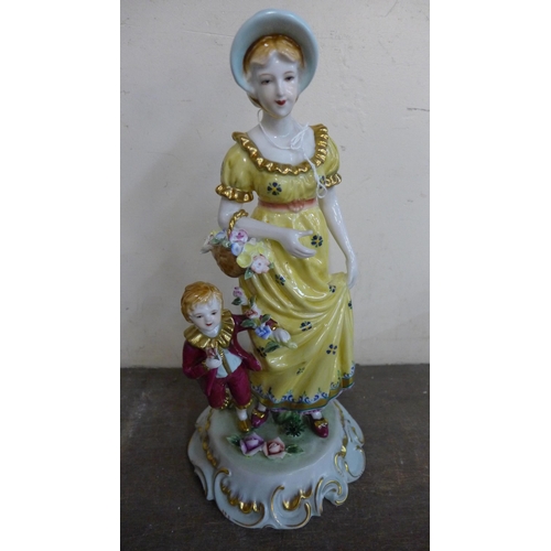 318 - A Dresden style painted porcelain figure of a lady and child