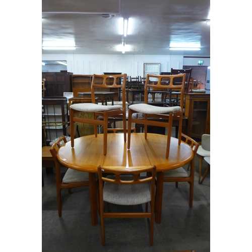 32 - A teak extending dining table and six chairs