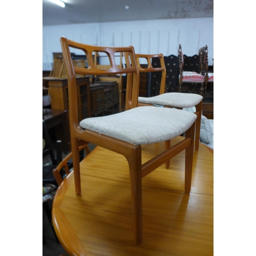 32 - A teak extending dining table and six chairs