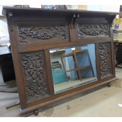 320 - An early 20th Century carved oak overmantel mirror