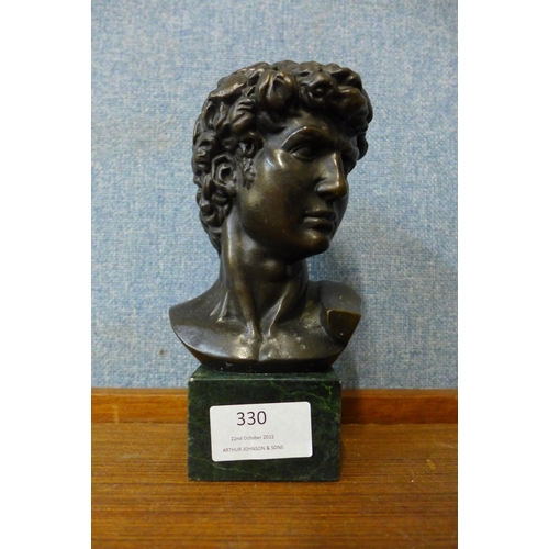 330 - A small bronze bust on green marble socle