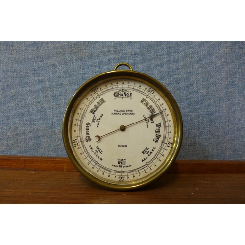 333 - A small early 20th Century brass marine barometer, the dial signed Pollock Bros. Marine Opticians, D... 