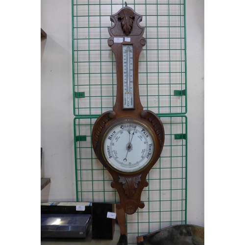 334 - A Victorian carved oak aneroid barometer