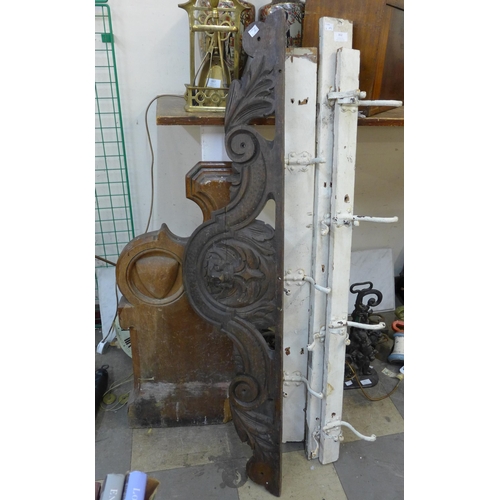 352 - A Church pew end, three coat hooks, carved pediment and a marble hearth