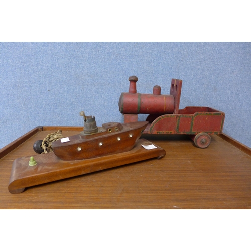 365 - A teak table lamp in the form of a ship and a hand painted wooden toy