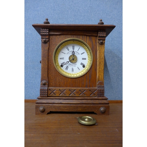 377 - An early 20th Century oak mantel clock, the dial signed Fattorini & Sons, Bradford