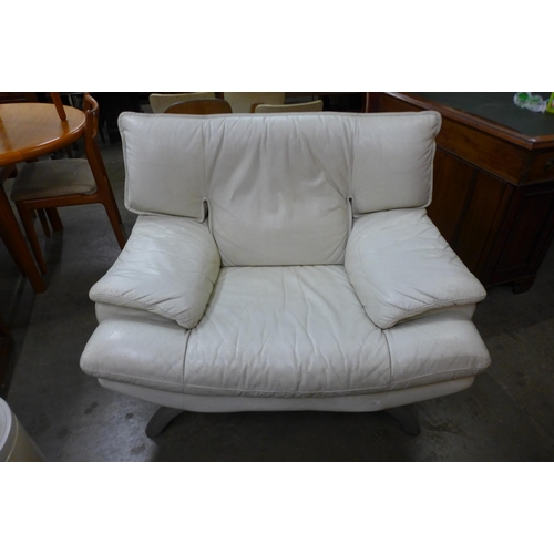 41 - A vintage white leather and chrome armchair