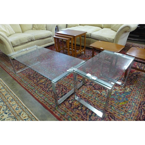 42 - A chrome and glass topped coffee table with matching occasional table