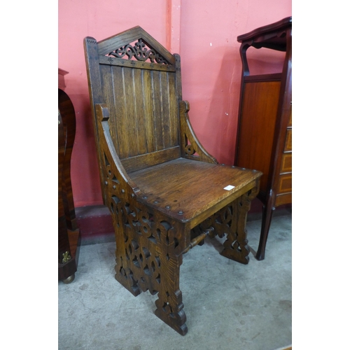46 - A Victorian Gothic Revival carved oak hall chair, manner of A.W.N Pugin