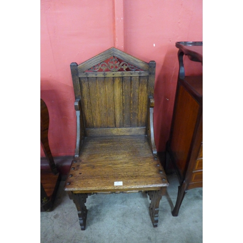 46 - A Victorian Gothic Revival carved oak hall chair, manner of A.W.N Pugin