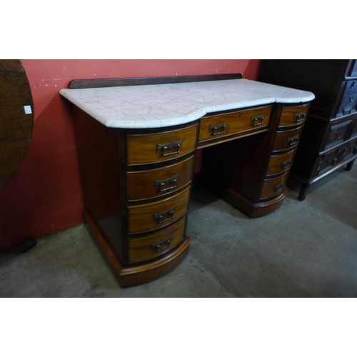 64 - A Victorian mahogany and marble topped kneehole desk