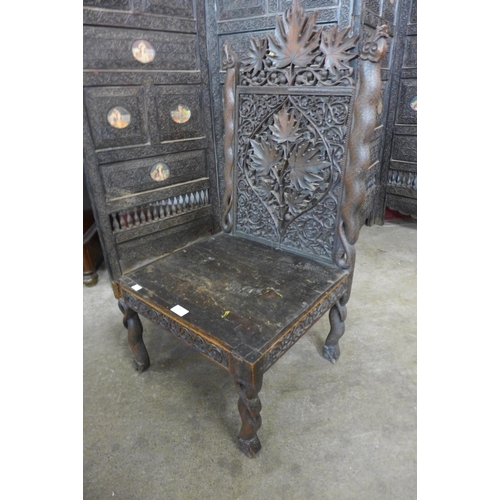 69 - An Indian carved hardwood chair