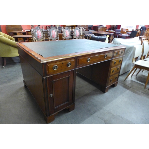 82 - An Edward VII mahogany and green leather topped partner's desk