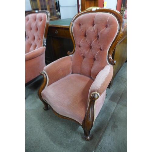 83B - A Victorian carved mahogany and fabric upholstered button-back armchair