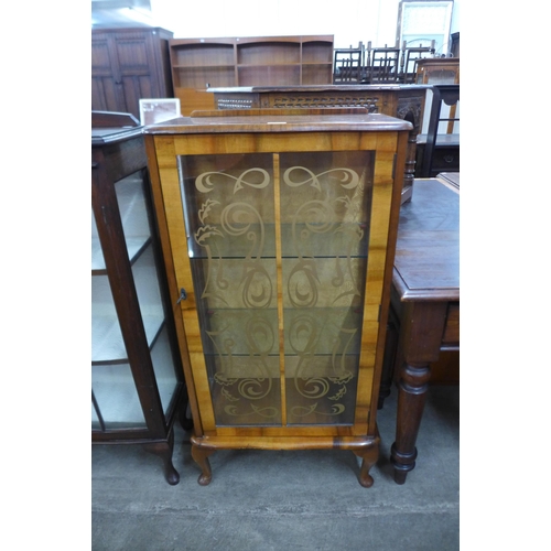 98 - A walnut single door display cabinet