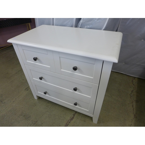 1500 - A white painted cot bed and chest of drawers