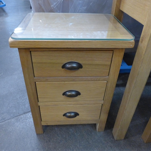 1409 - An oak dressing table with stool and a three drawer bedside chest