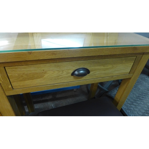 1409 - An oak dressing table with stool and a three drawer bedside chest