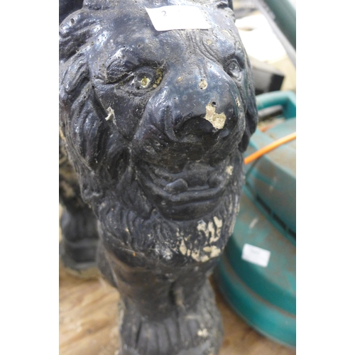 2413 - Pair of black painted stone lion garden ornaments