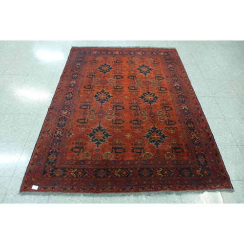 141 - A hand knotted red ground rug, 200 x 152cms
