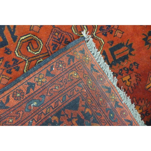 141 - A hand knotted red ground rug, 200 x 152cms