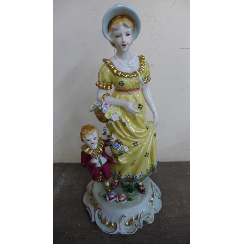 387 - A Dresden style painted porcelain figure of a lady and child