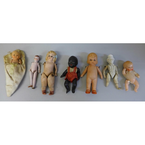 635 - Seven small antique all bisque dolls, largest 10cm