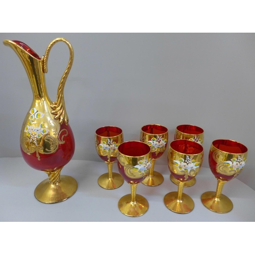 681 - A red glass liqueur set with gilt decoration