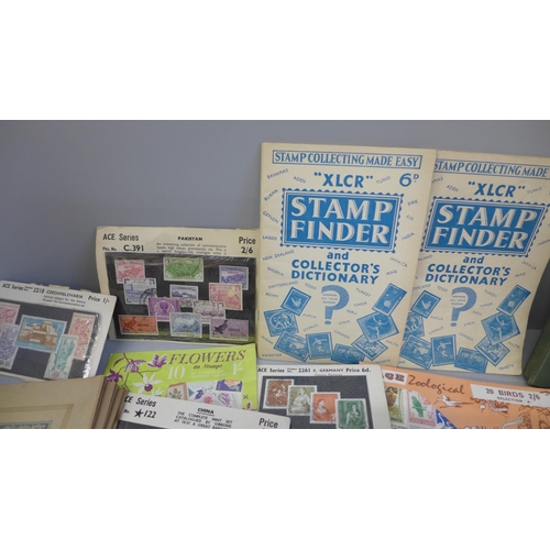 688 - A small collection of stamps including old shop stock on cards, a standard catalogue of world stamps... 