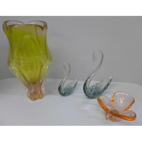 697 - Four items of art glass including two swans, large vase with chips to base