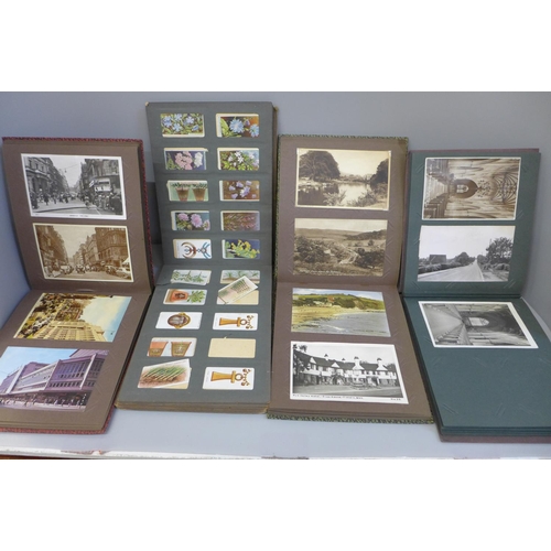 700 - Three albums of postcards, Edwardian and later and an album of early 20th Century cigarette cards