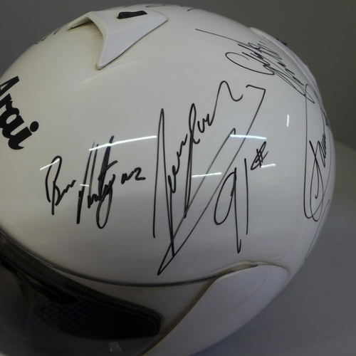 742 - An Arai crash helmet, signed, (de-lacquered, signed and re-lacquered), signatures include Cal Crutch... 