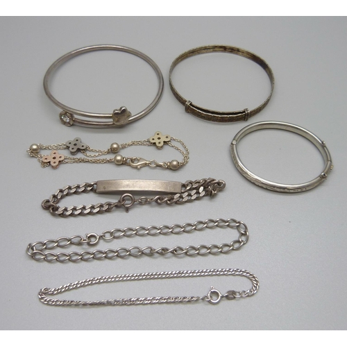 939 - Four silver bracelets and three silver bangles including one child's, 46g