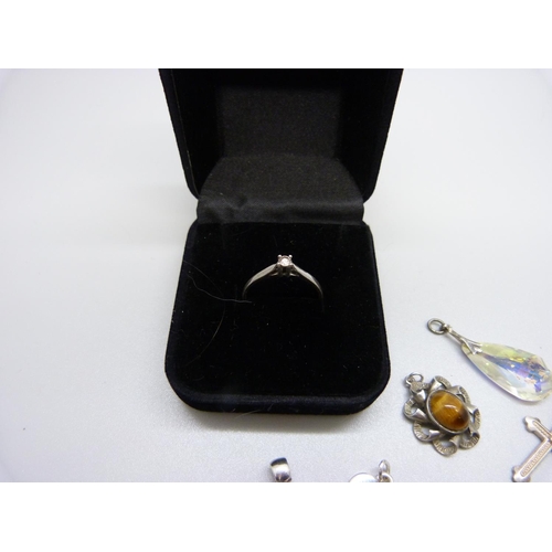 941 - A silver and diamond ring, size Q, and assorted silver pendants, charms, etc.